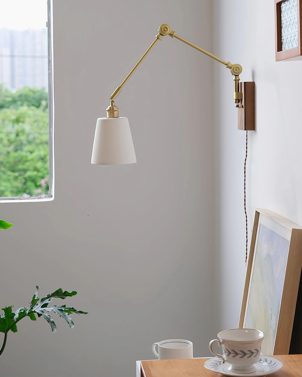 Lit swing arm wall lamp casting ambient light from conical ceramic shade in contemporary space