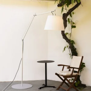 Modern swing arm floor lamp in minimalist corner setting with side table, adjustable metal arm and fabric lampshade detail