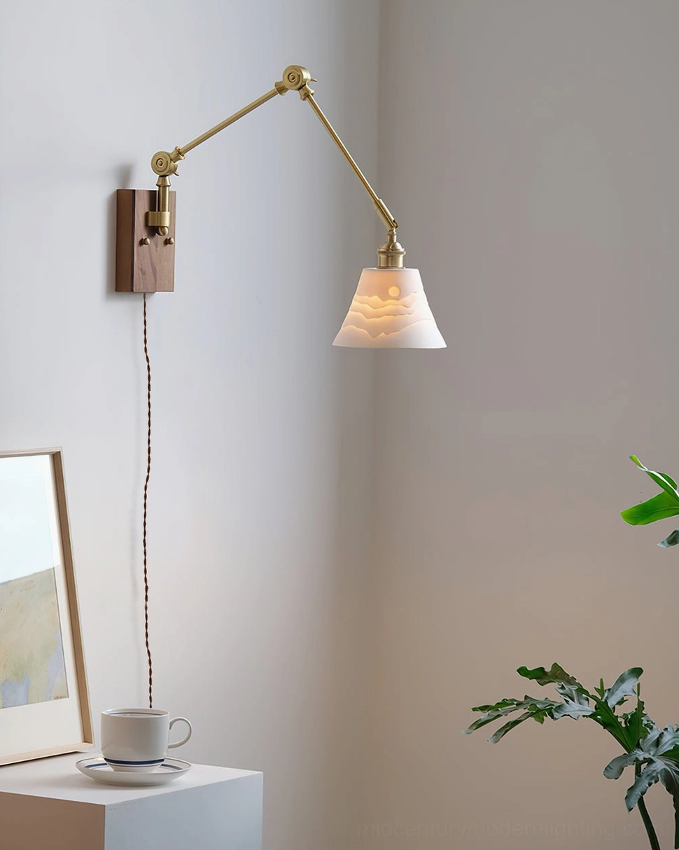 Ceramic swing arm wall lamp with walnut base in minimalist home corner with exposed cord