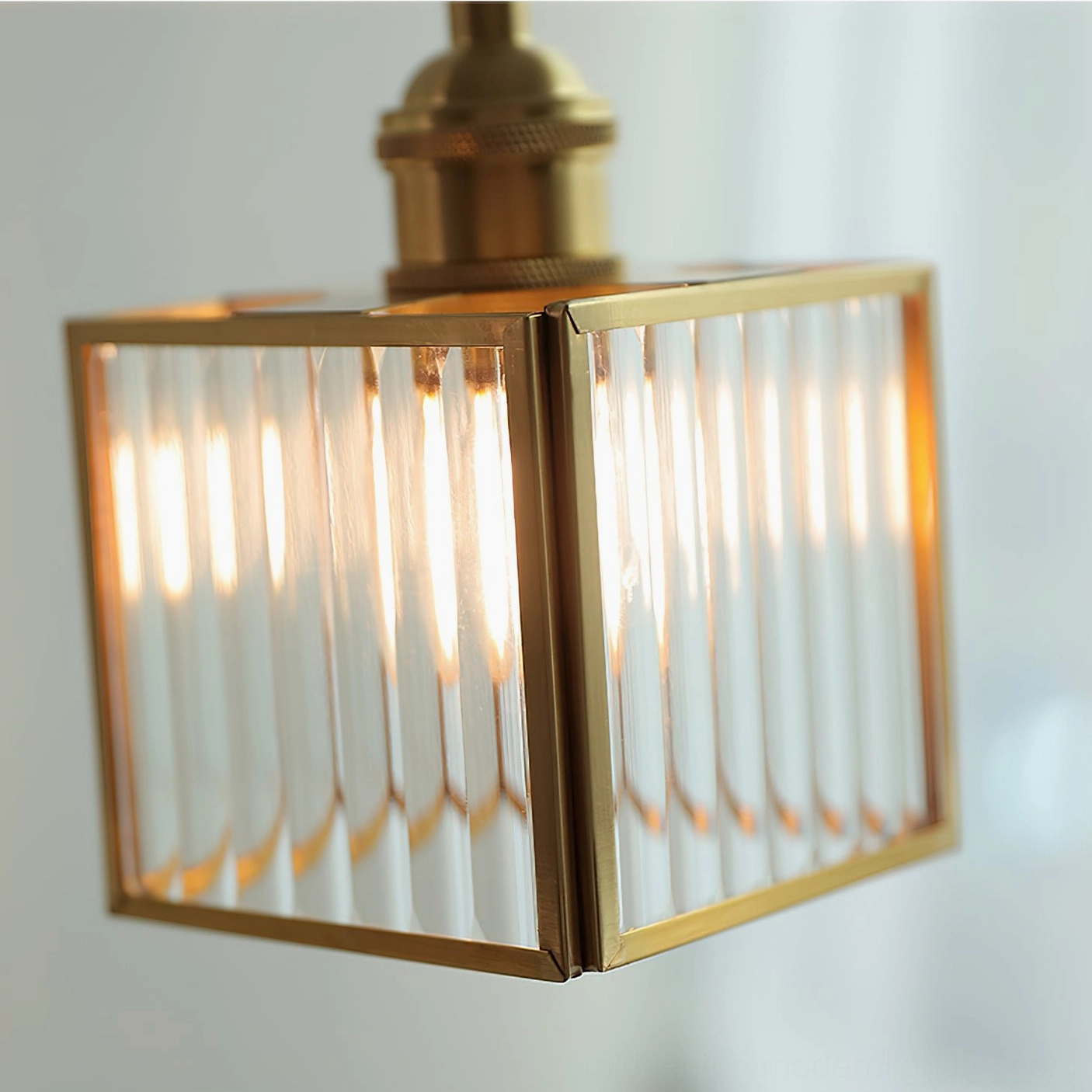Close-up detail of ribbed glass lamp shade with brass frame showing vertical texture pattern and craftsmanship