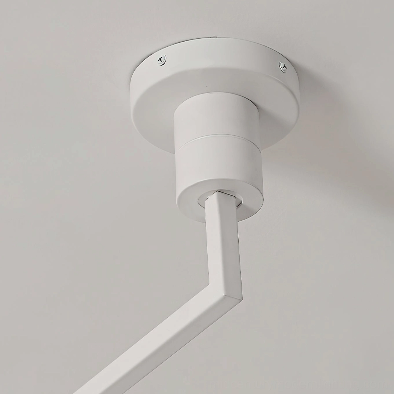 White ceiling-mounted canopy and swing arm mechanism, close-up industrial detail view