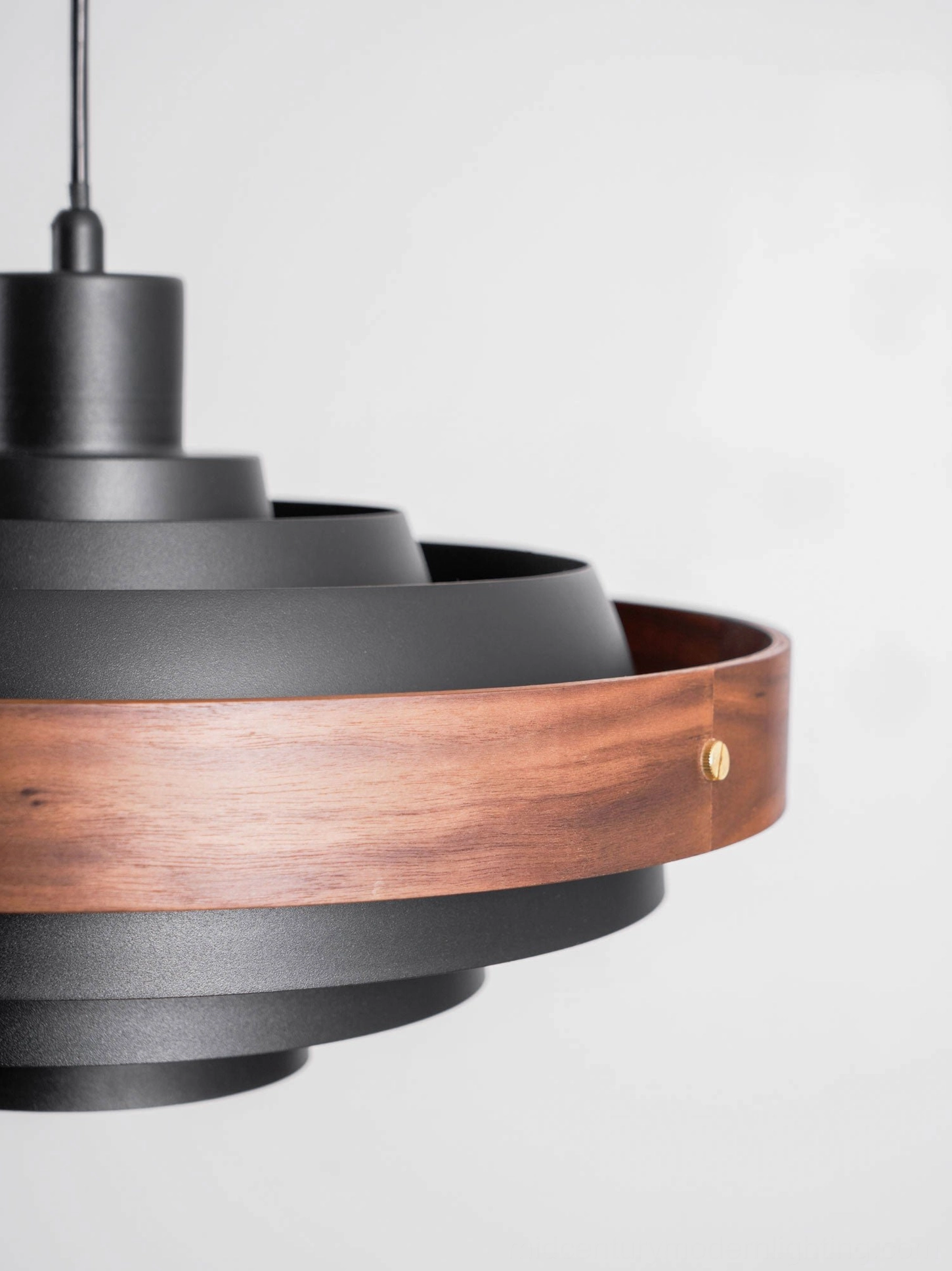 Four colorway finish options for Rancho swing arm pendant: black, walnut, wood, white