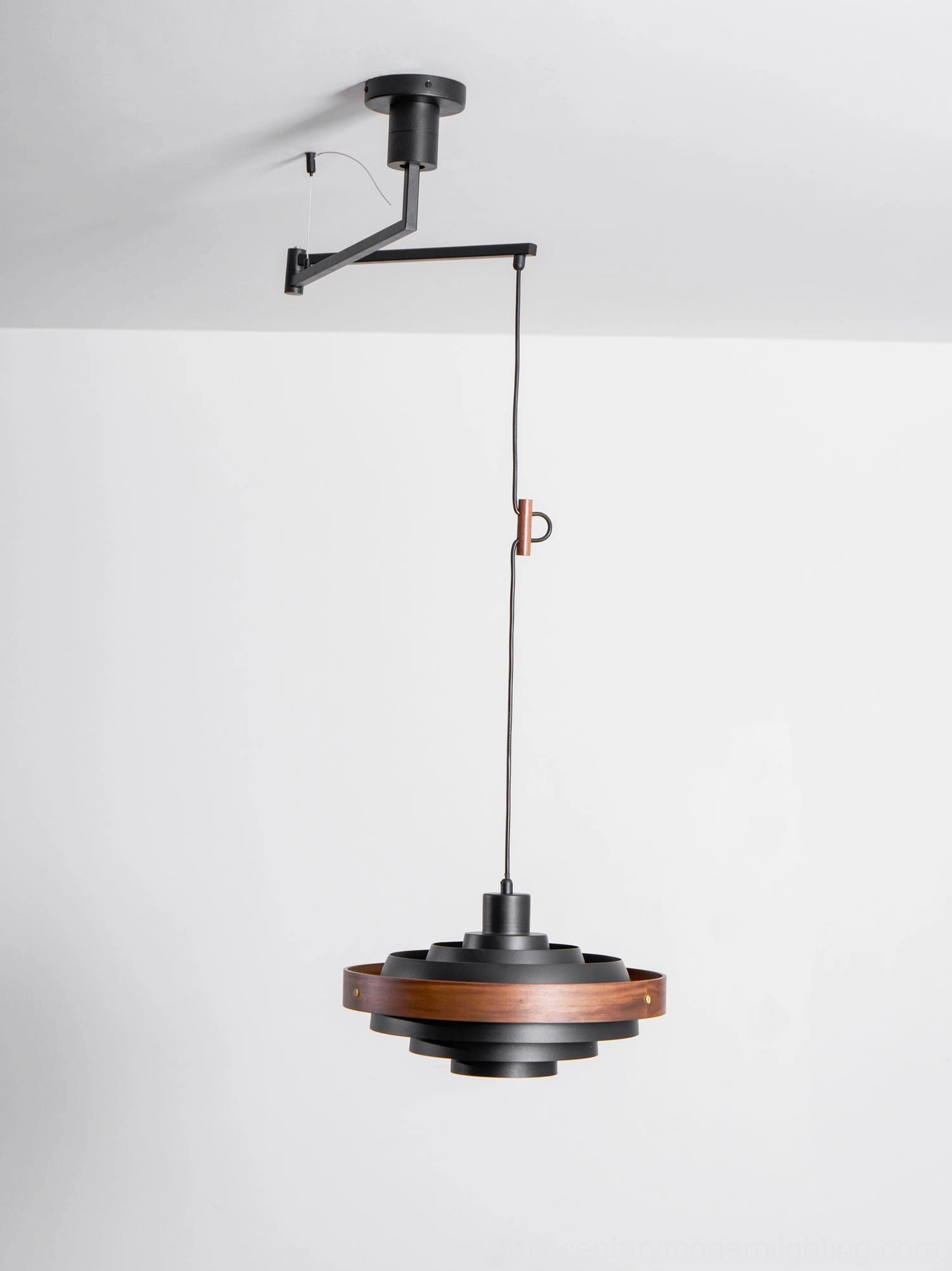 Adjustable swing arm pendant light with wood finish shade in industrial loft interior