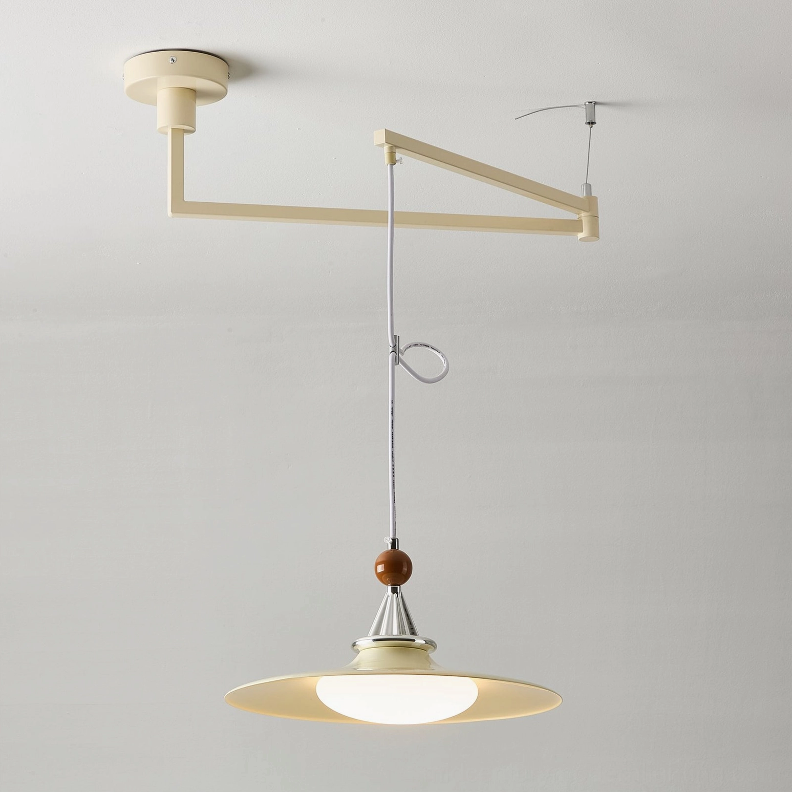 Detailed view of Eden swing arm pendant light shade interior and lighting diffusion pattern from warm LED source