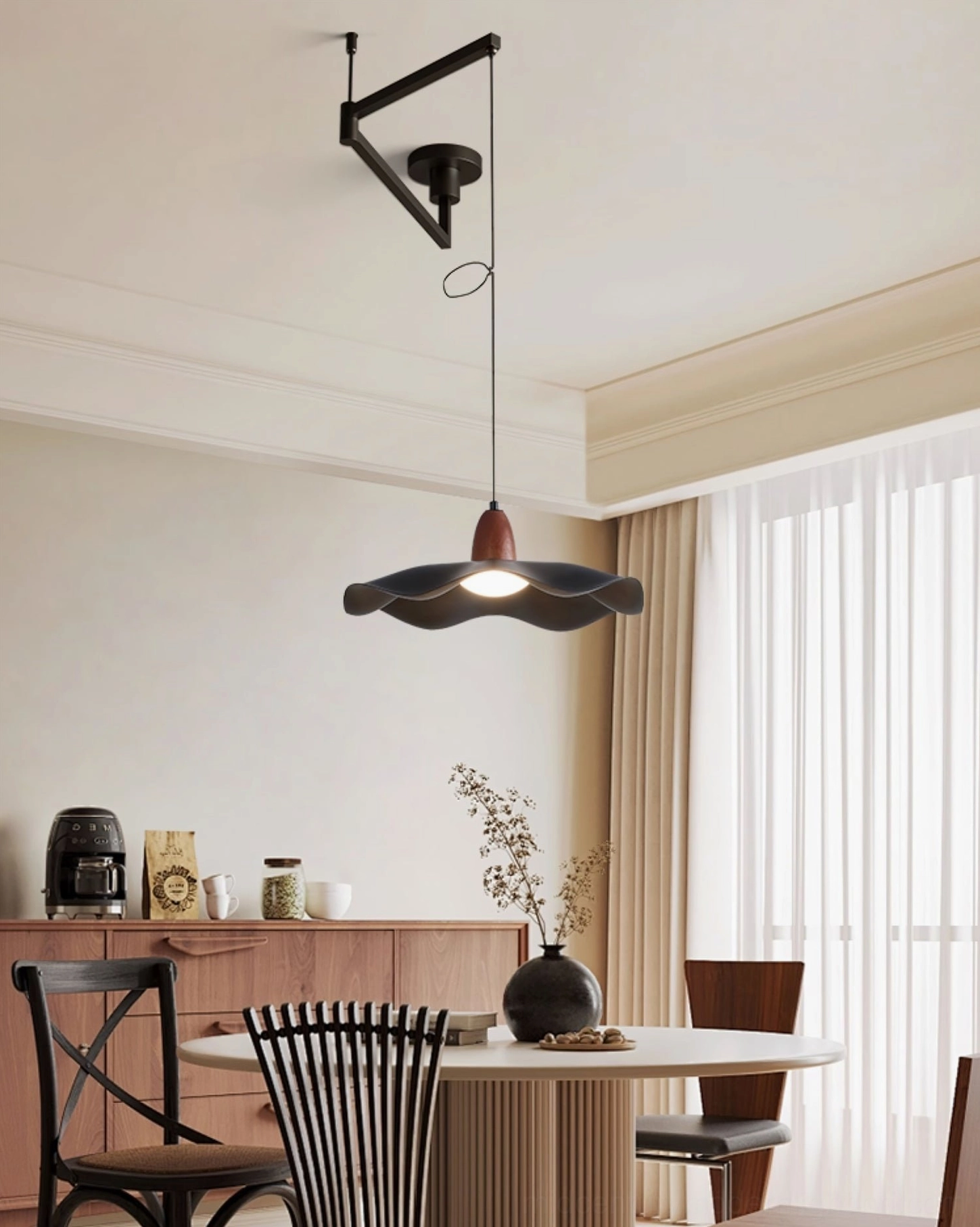 Contemporary wavy pendant light illuminating warm modern dining corner with side cabinet and minimalist décor