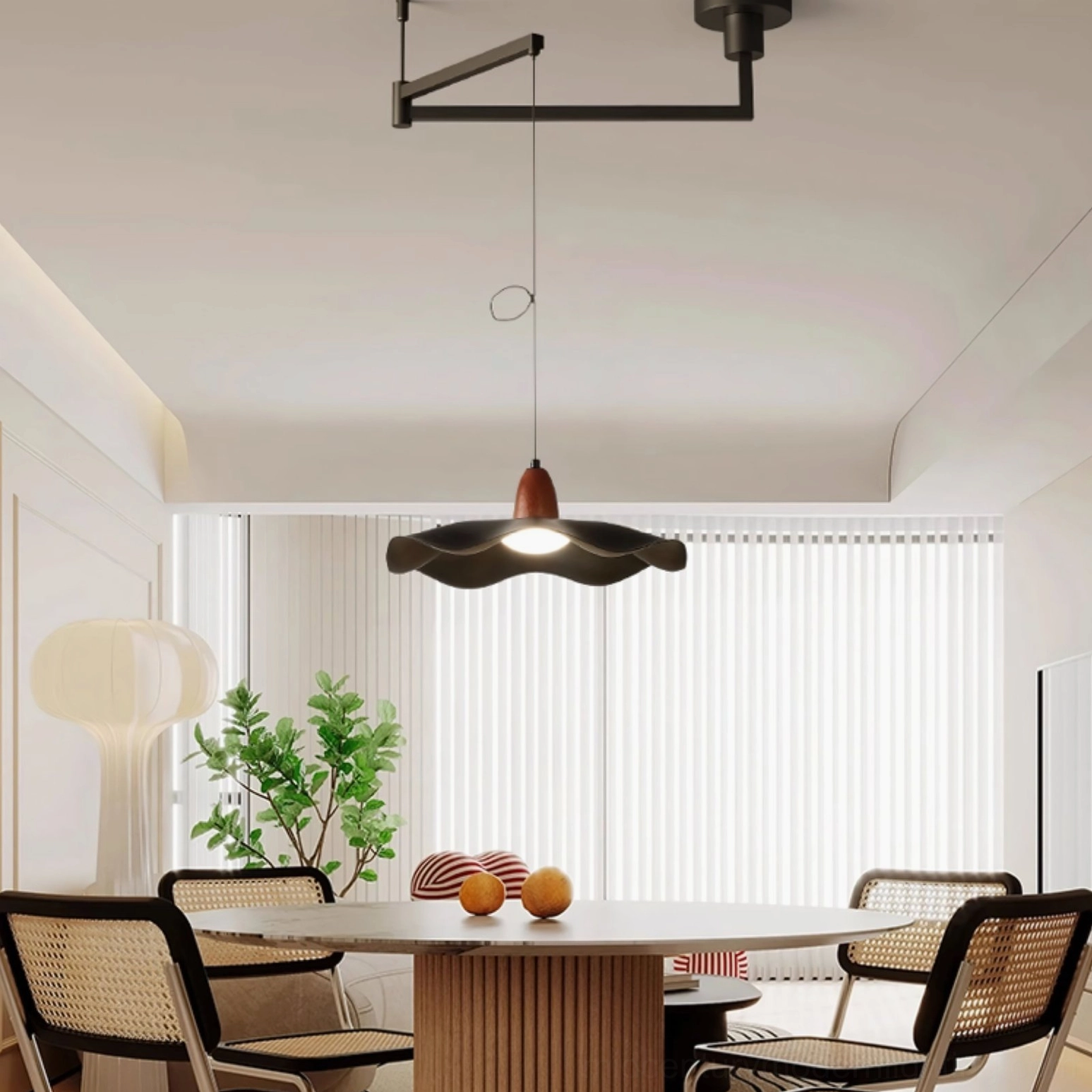 Sculptural wavy pendant light in bright minimalist dining area with open kitchen and warm cream tones