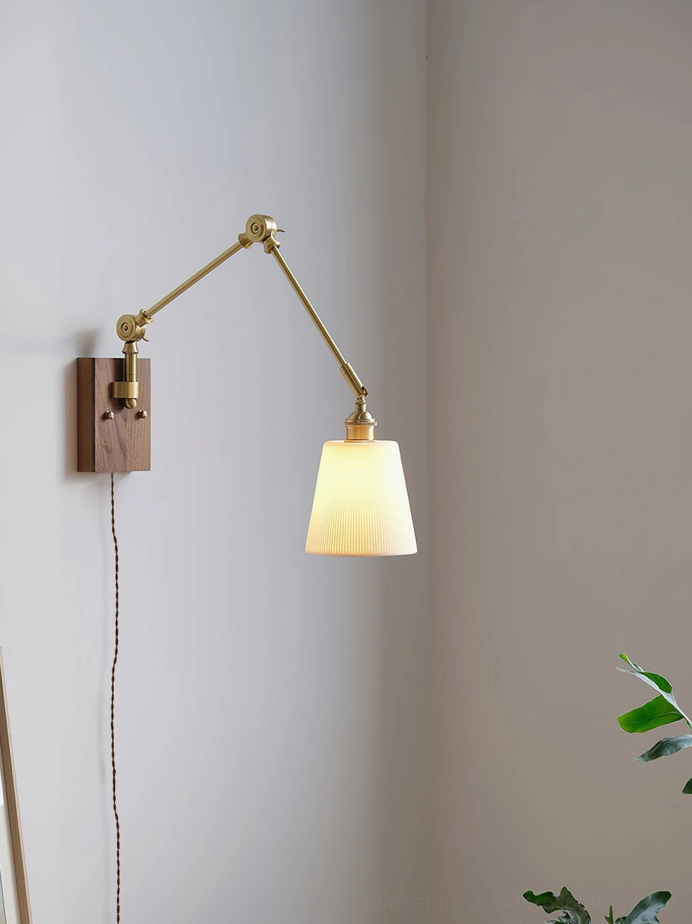 Illuminated swing arm wall lamp with plain conical ceramic shade and brass metal hardware