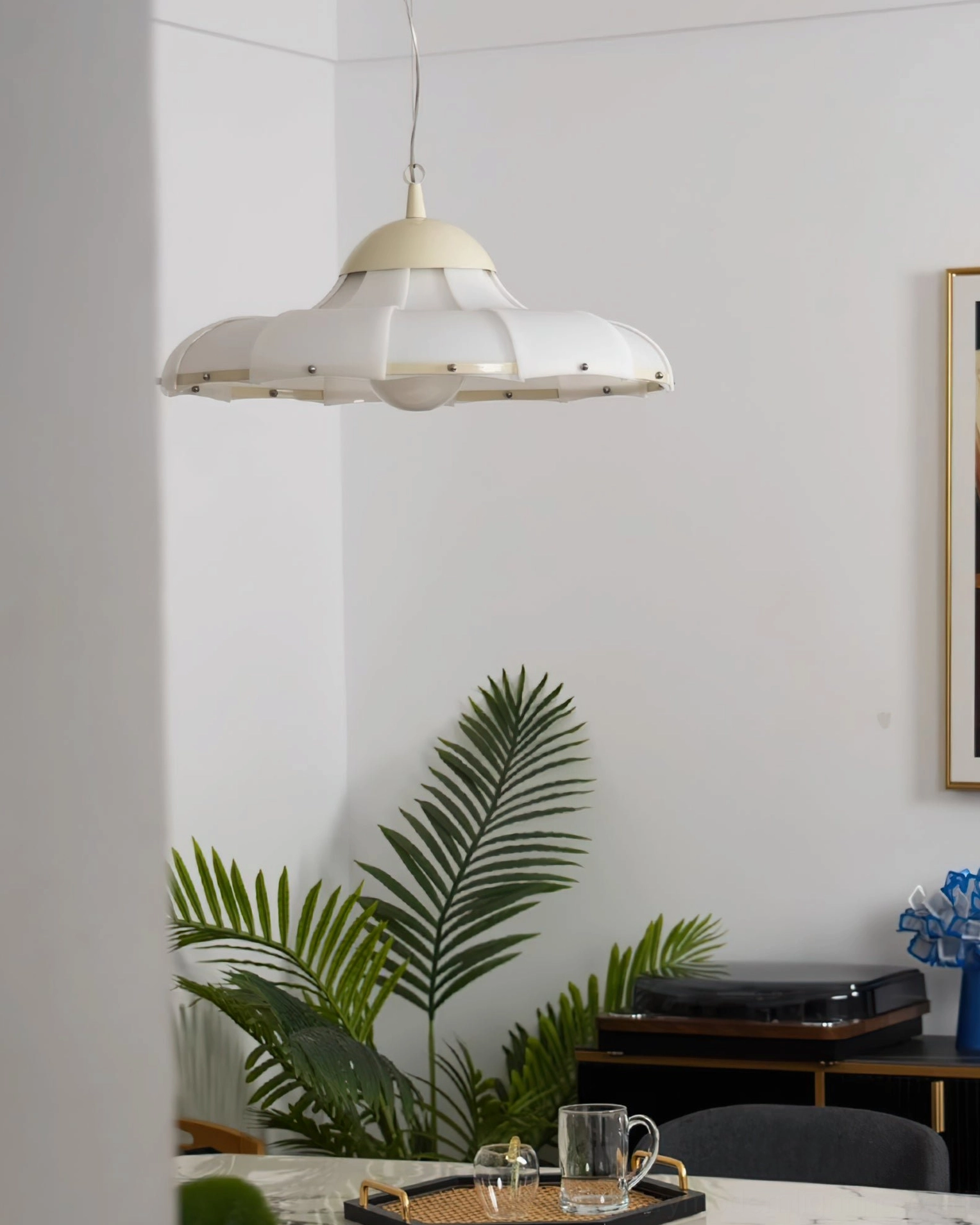 Swirl pendant lamp in minimalist boho corner with tropical greenery and warm interior lighting