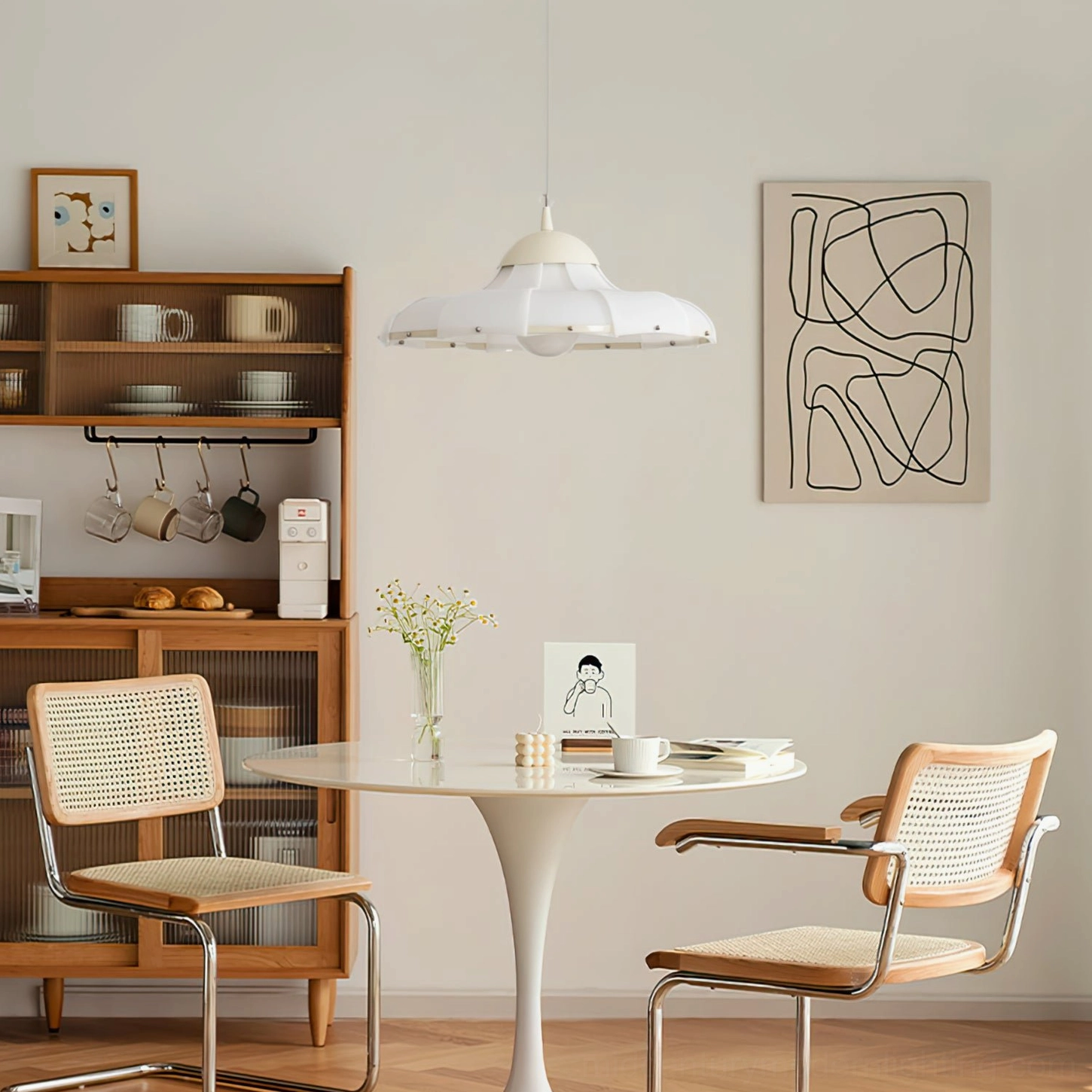 Swirl pendant ceiling light in compact apartment dining space with Bauhaus décor and storage cabinet