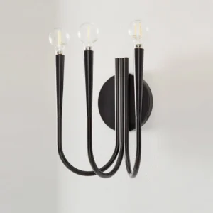 Swoop matte black wall sconce close-up showing sleek curved metal arms and minimalist silhouette on white interior wall