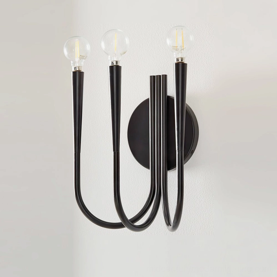 Swoop matte black wall sconce close-up showing sleek curved metal arms and minimalist silhouette on white interior wall