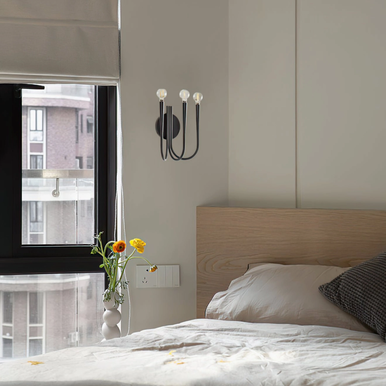 Swoop wall sconce curved metal arms detail showing precision craftsmanship and elegant swooping silhouette