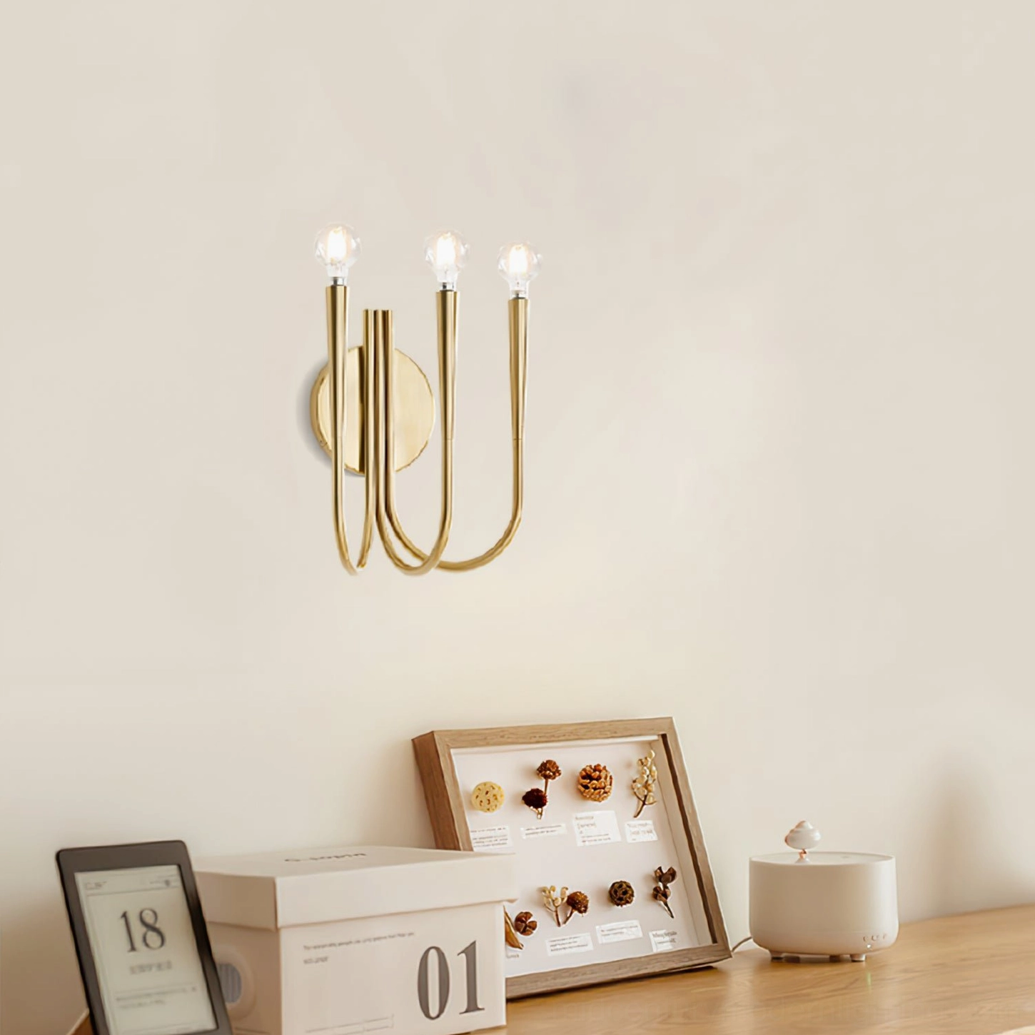 Swoop wall sconce installed above modern home office vanity area with warm neutral styling and minimalist decor