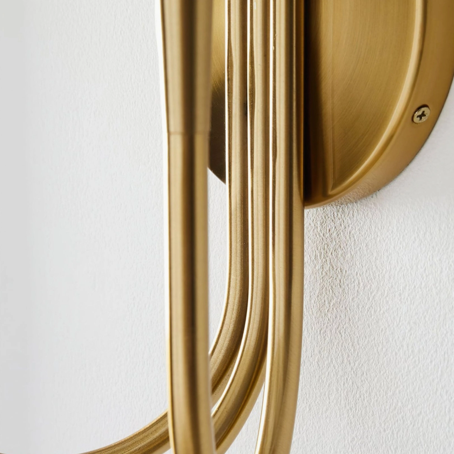 Swoop wall sconce mounting hardware and side view detail showing brushed brass finish and curved metal frame construction