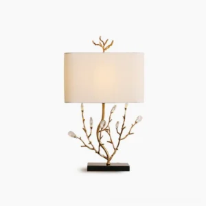 Sylvia brass branch table lamp with crystalline buds on white studio background, showing gold metal base and fabric shade