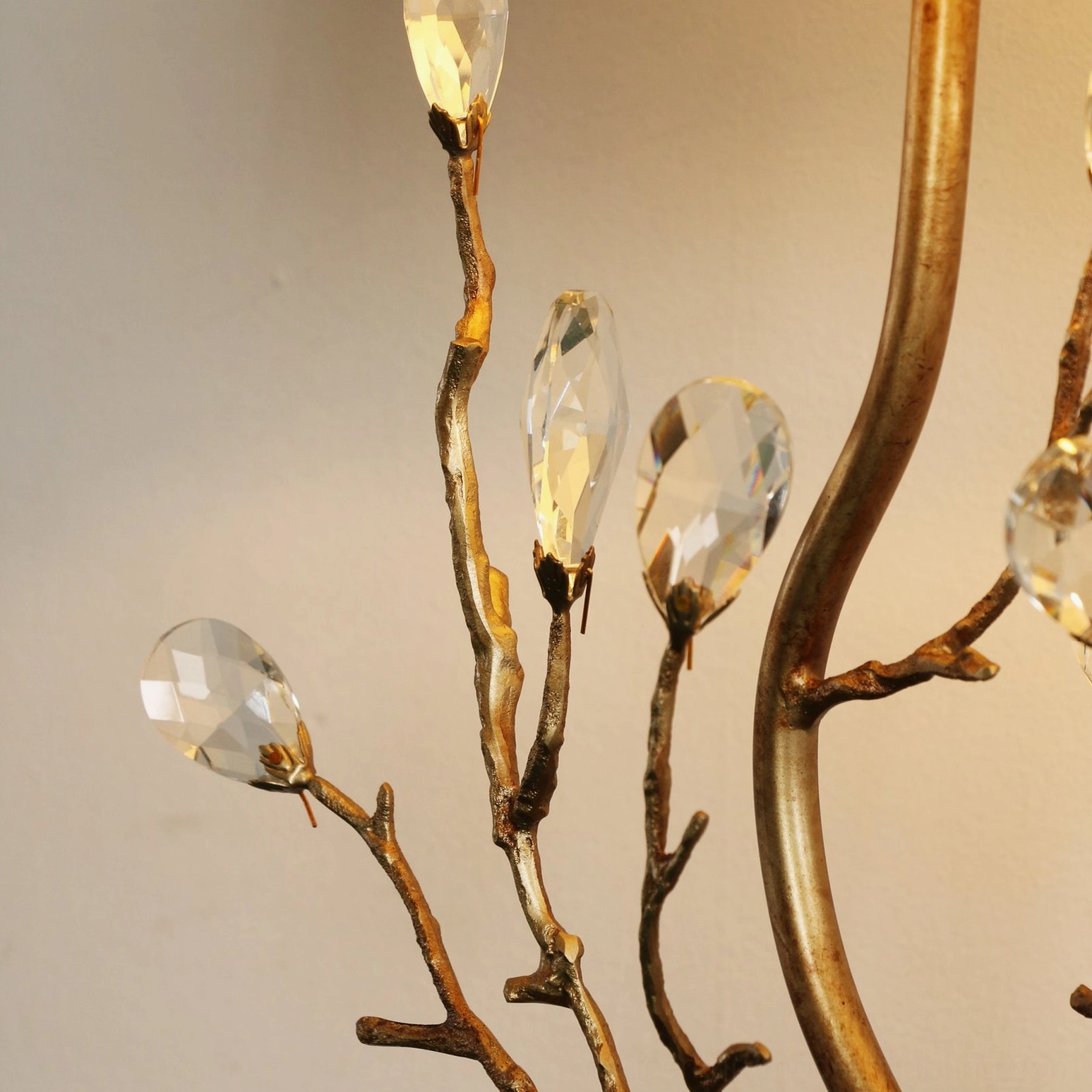 Close-up macro detail of Sylvia lamp crystalline buds and faceted brass branch texture with gold finish