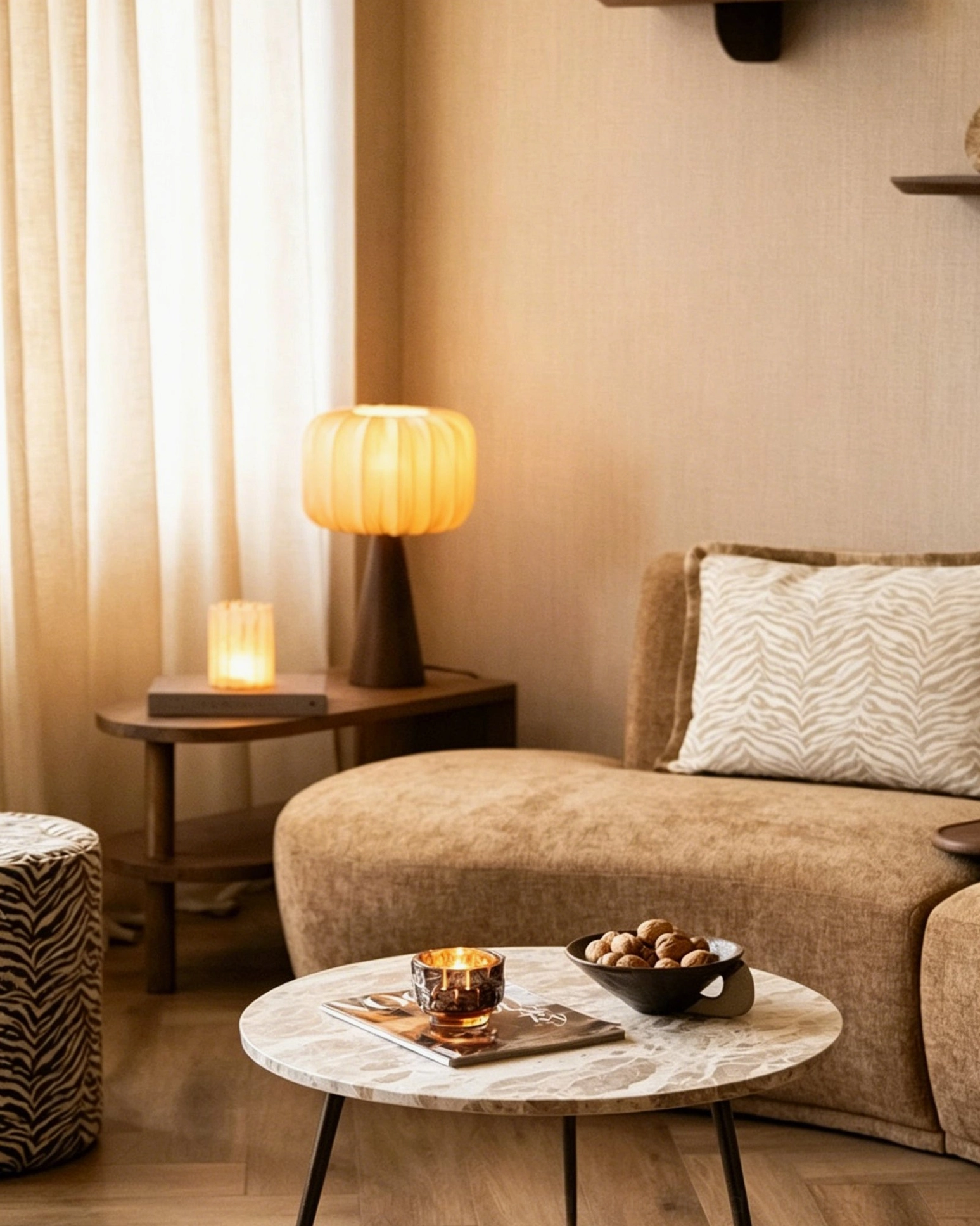 Talia table lamp illuminated in cozy modern living room with brown sofa and marble coffee table warm ambient lighting