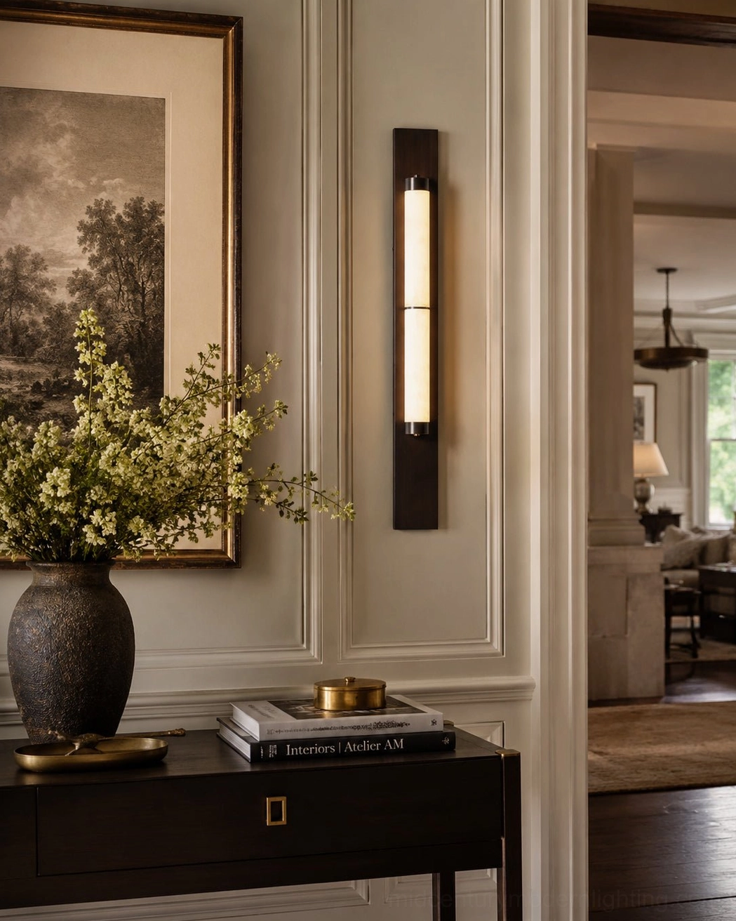 Tall black alabaster wall lamp in formal entryway with console table, neoclassical interior design