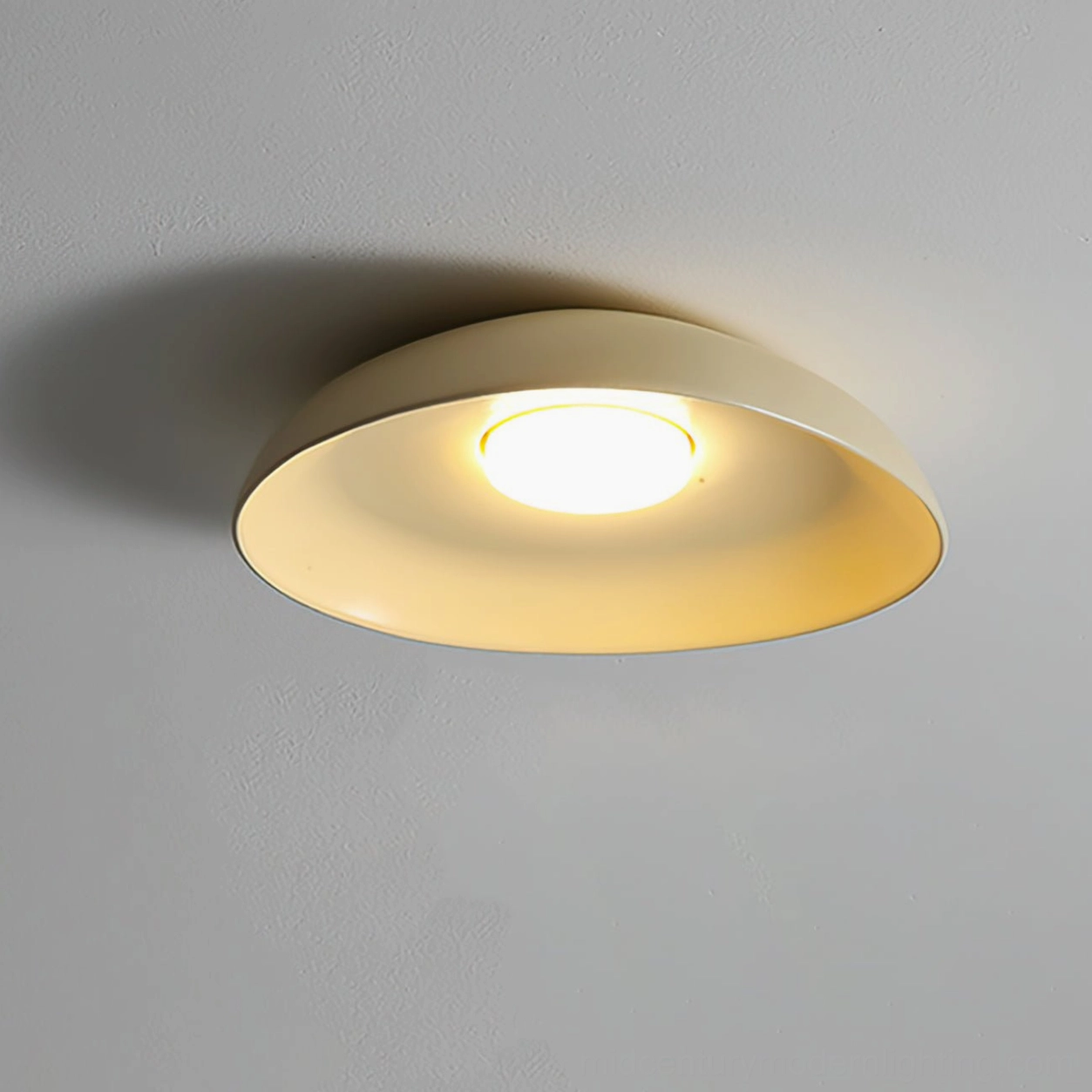 Tambo modern flush mount ceiling lamp in cream color finish, studio product photography minimal background