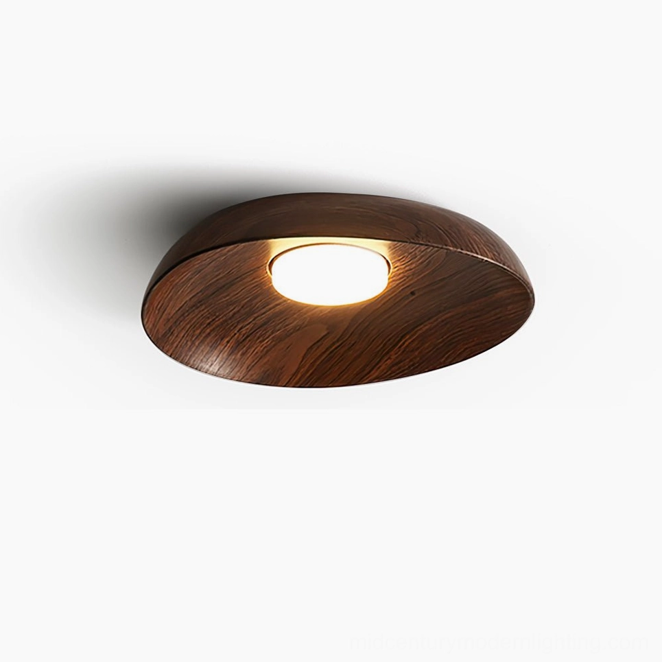Tambo modern flush mount ceiling lamp in walnut finish, overhead studio close-up showing rounded silhouette and wood grain resin texture