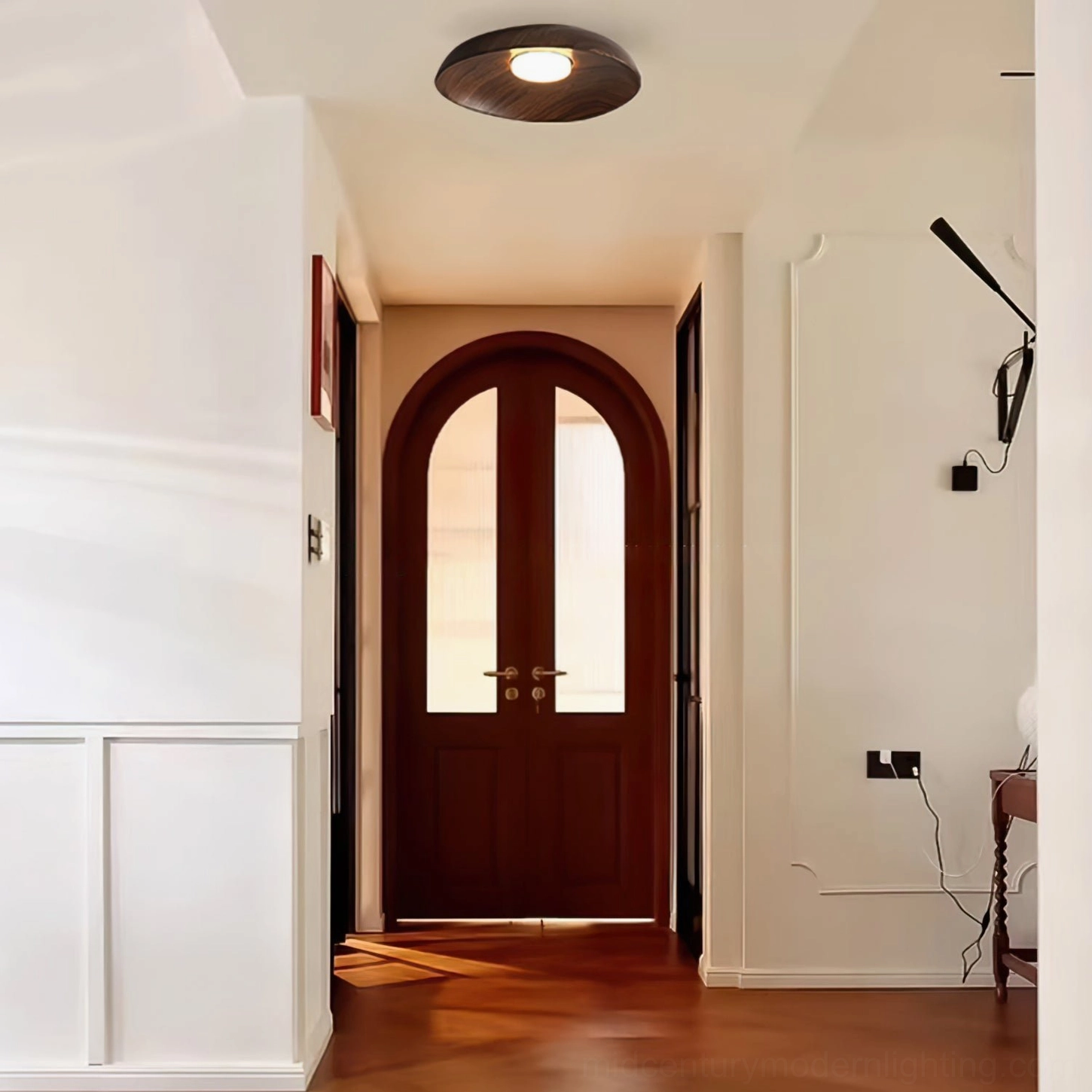 Tambo resin ceiling lamp in home hallway with arched wooden door, vintage minimalist interior aesthetic