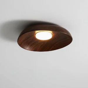 Tambo ceiling lamp installed on white ceiling, side-angle view demonstrating low-profile flush design and warm resin finish