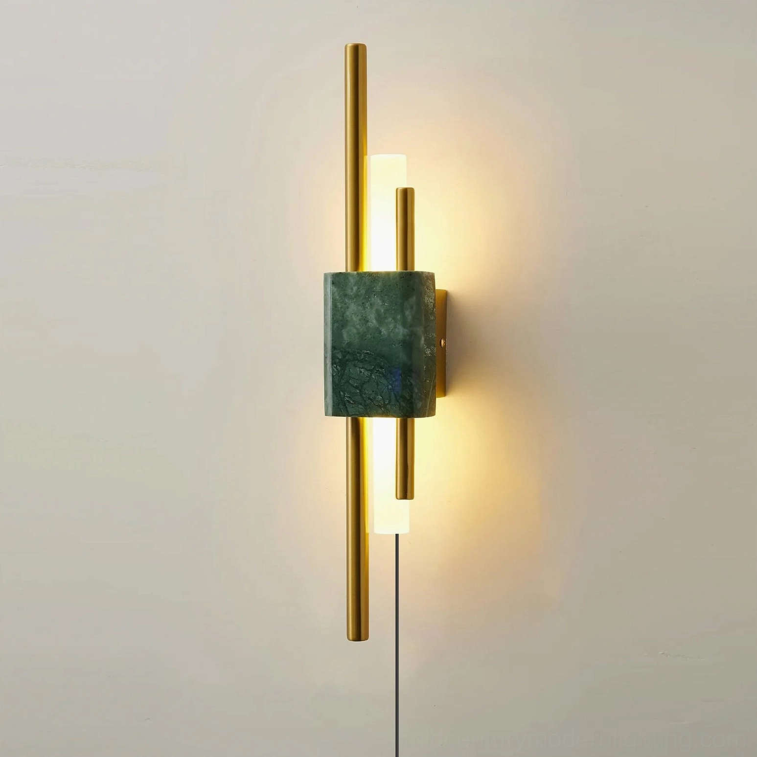 Close-up detail of Tanto sconce with deep green marble socket, exposed power cord, and warm LED illumination