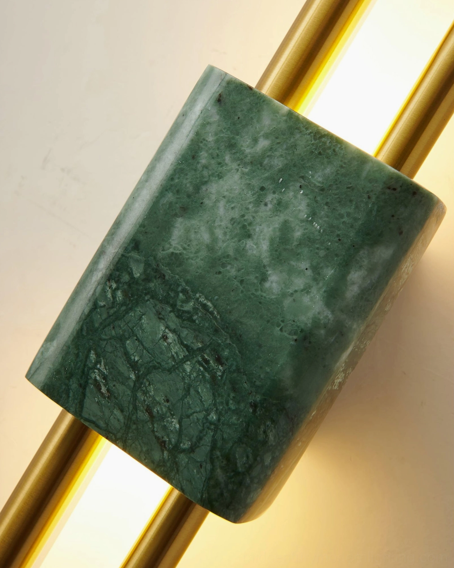 Illuminated Tanto wall sconce with warm glowing light and green marble detail - contemporary sculptural wall light