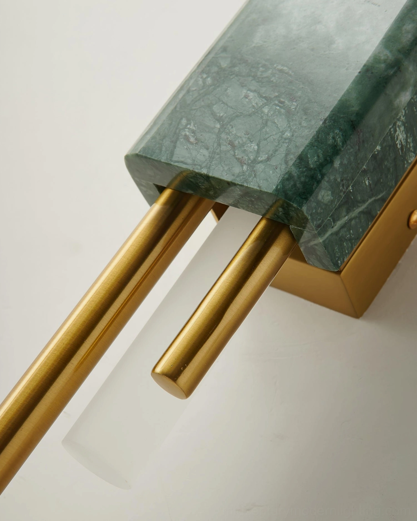 Close-up detail of Tanto marble base and polished brass rods - natural stone texture and brass accents