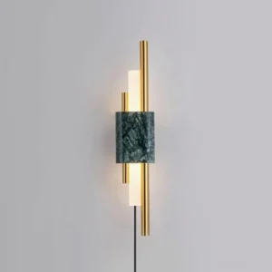 Front view of Tanto wall lamp featuring white marble base with polished gold metal rods and integrated LED light