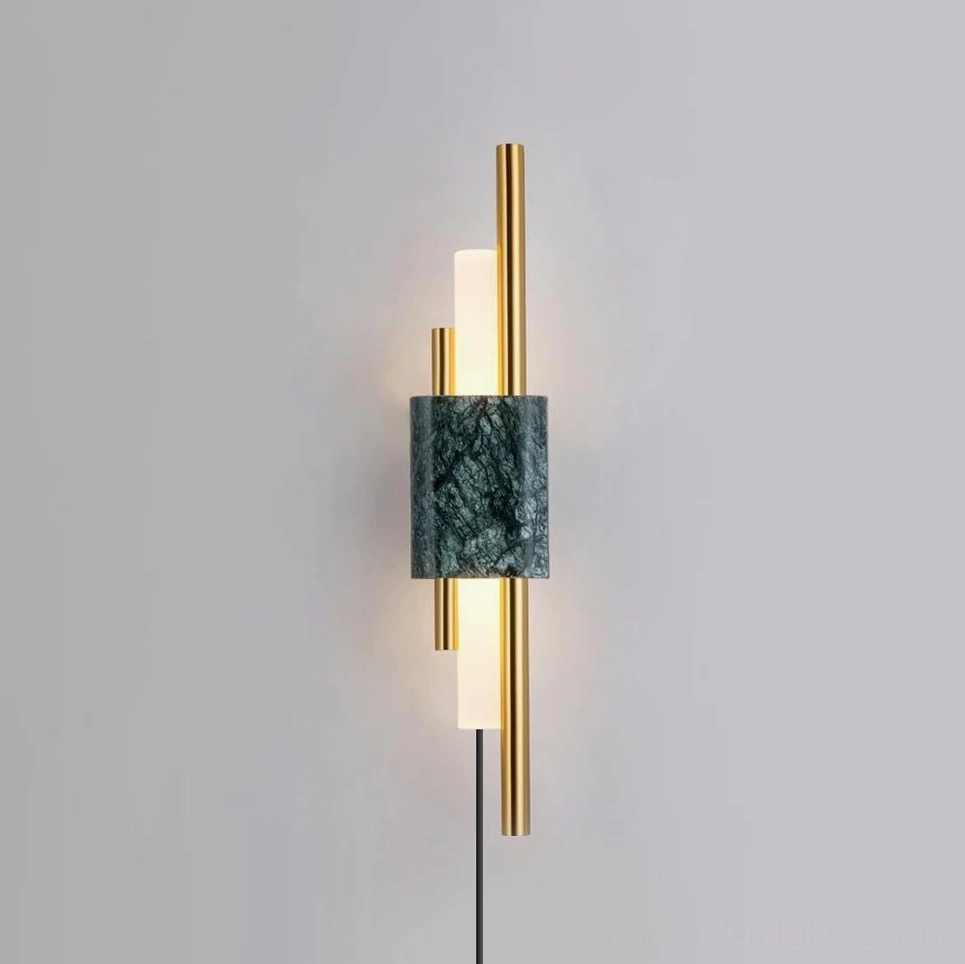 Front view of Tanto wall lamp featuring white marble base with polished gold metal rods and integrated LED light