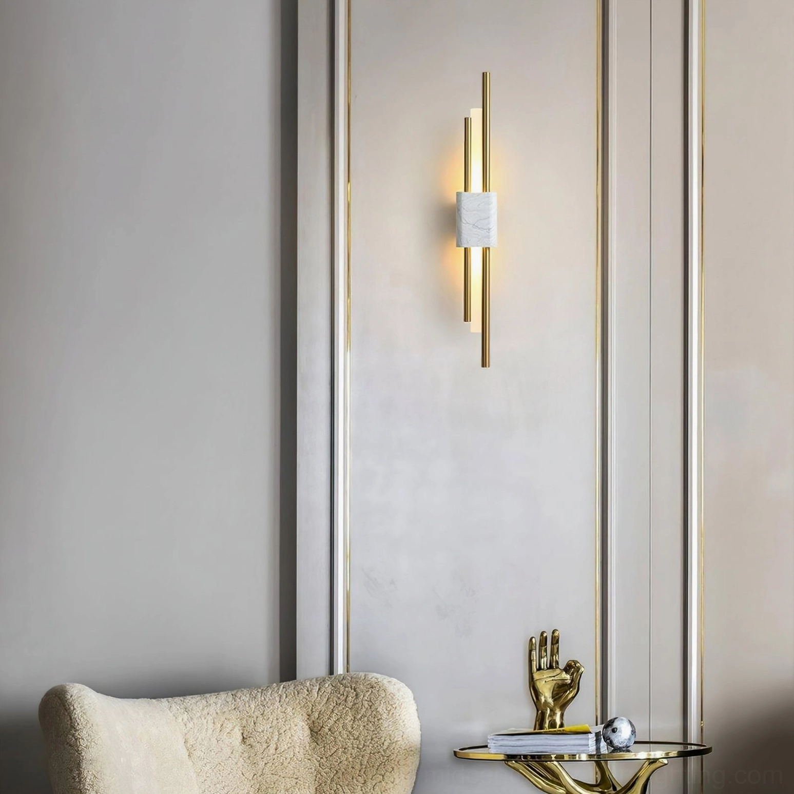 Tanto white marble wall sconce with brass hardware above mirrored accent wall in modern bedroom - luxury wall lighting