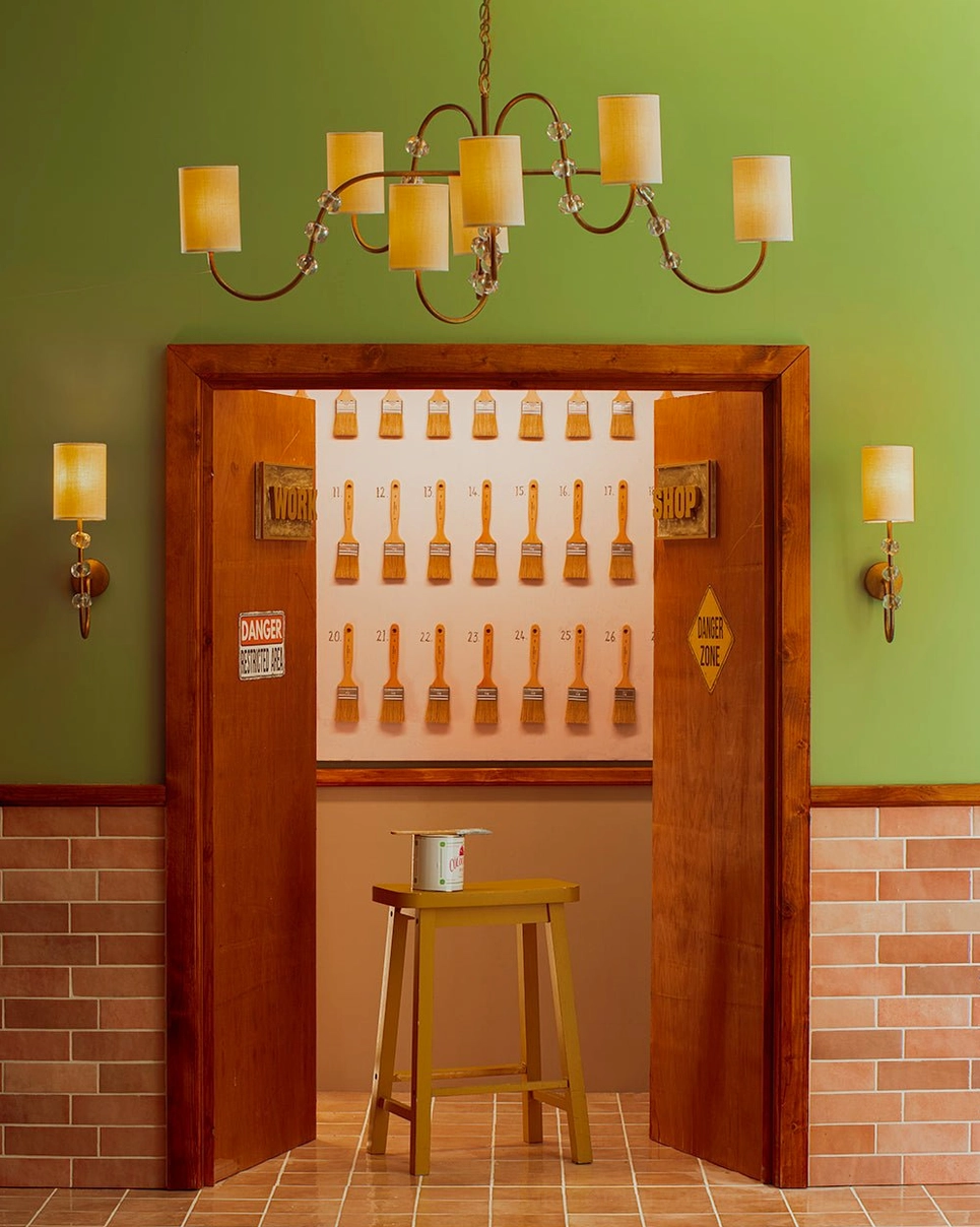 Tanyel chandelier installed in retro bar setting with warm yellow shades, gold metal finish, and atmospheric lighting ambiance