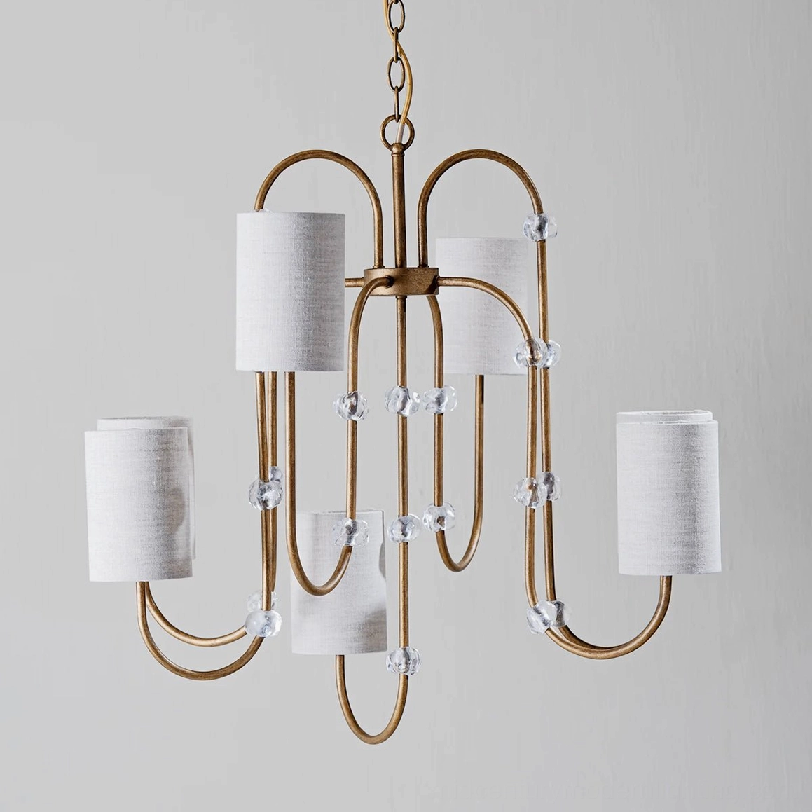 Tanyel five-light fabric chandelier with gold metal frame, clear crystal accents, and minimalist white shades