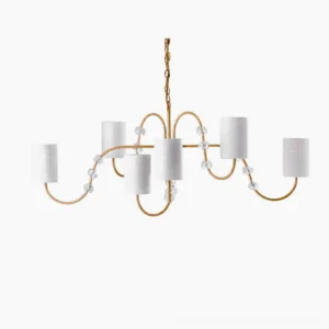 Tanyel six-light mid-century modern chandelier with curved brass arms, crystal bead accents, and white fabric drum shades frontal view