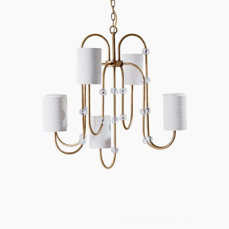 Tanyel model A compact chandelier with five lights, clustered crystal accents, brass structure, and white fabric drum shades