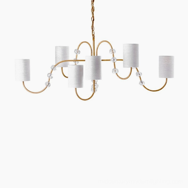 Tanyel model B statement chandelier with six lights, brass framework, crystal decoration, and white cylinder fabric shades