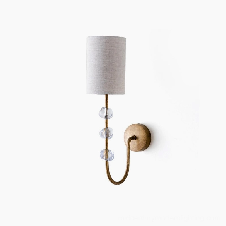 Tanyel single-light wall sconce with curved brass frame and stacked crystal glass beads, front view