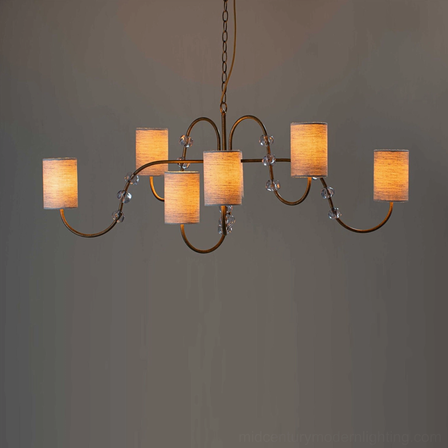 Tanyel six-light exposed bulb chandelier with gold metal frame, crystal accents, and warm Edison bulb covers