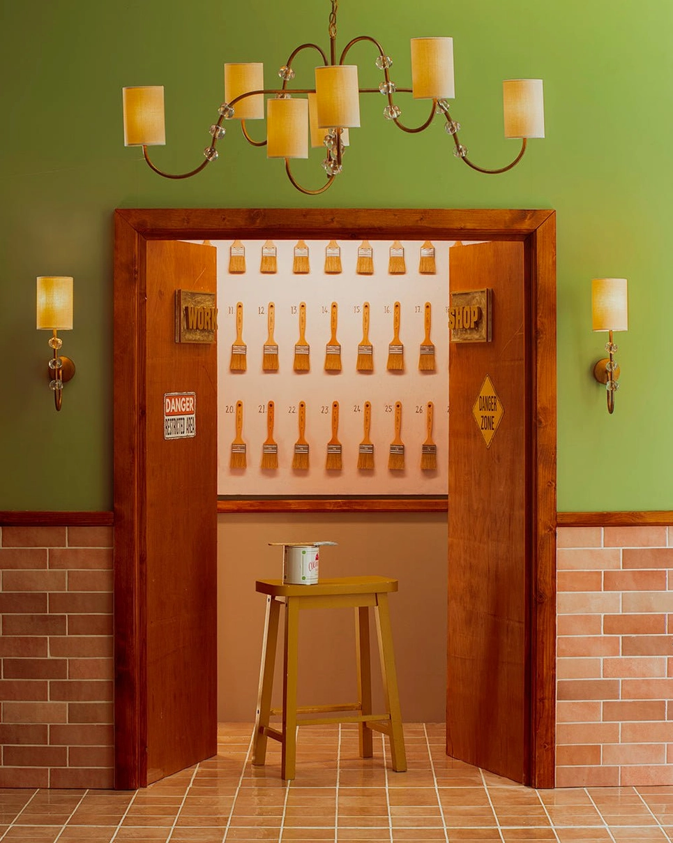 Tanyel wall sconces installed in vintage restaurant entrance with brick and green walls, warm decorative lighting