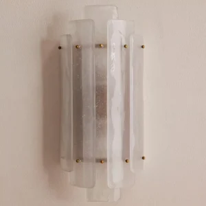 Close-up side angle of Tasha seeded glass sconce showing thick layered Art Deco texture and brass details
