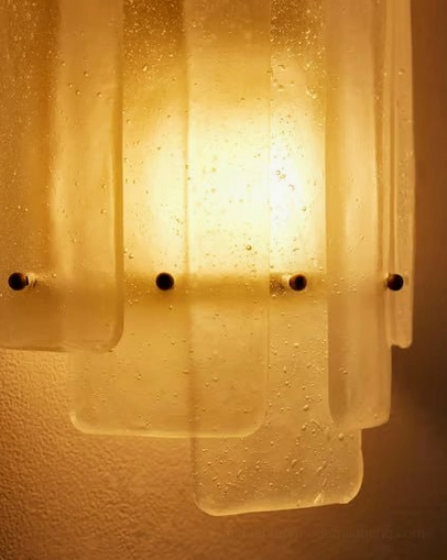 Ultra-close macro detail of Tasha sconce showing glass bubbles, texture, and brass hardware
