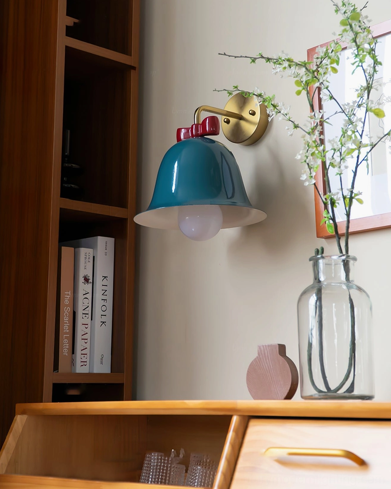 Teal blue Bow Bell Wall Lamp in home office with bookshelf and desk decor in cozy mid-century style