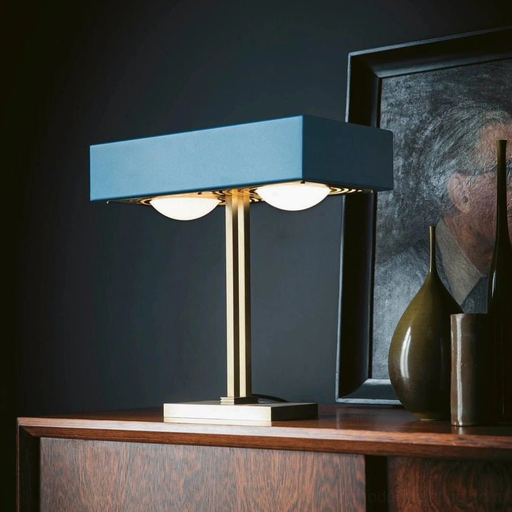 Teal matte Kernel table lamp with geometric laser-cut diffuser displayed on luxury bedroom dresser
