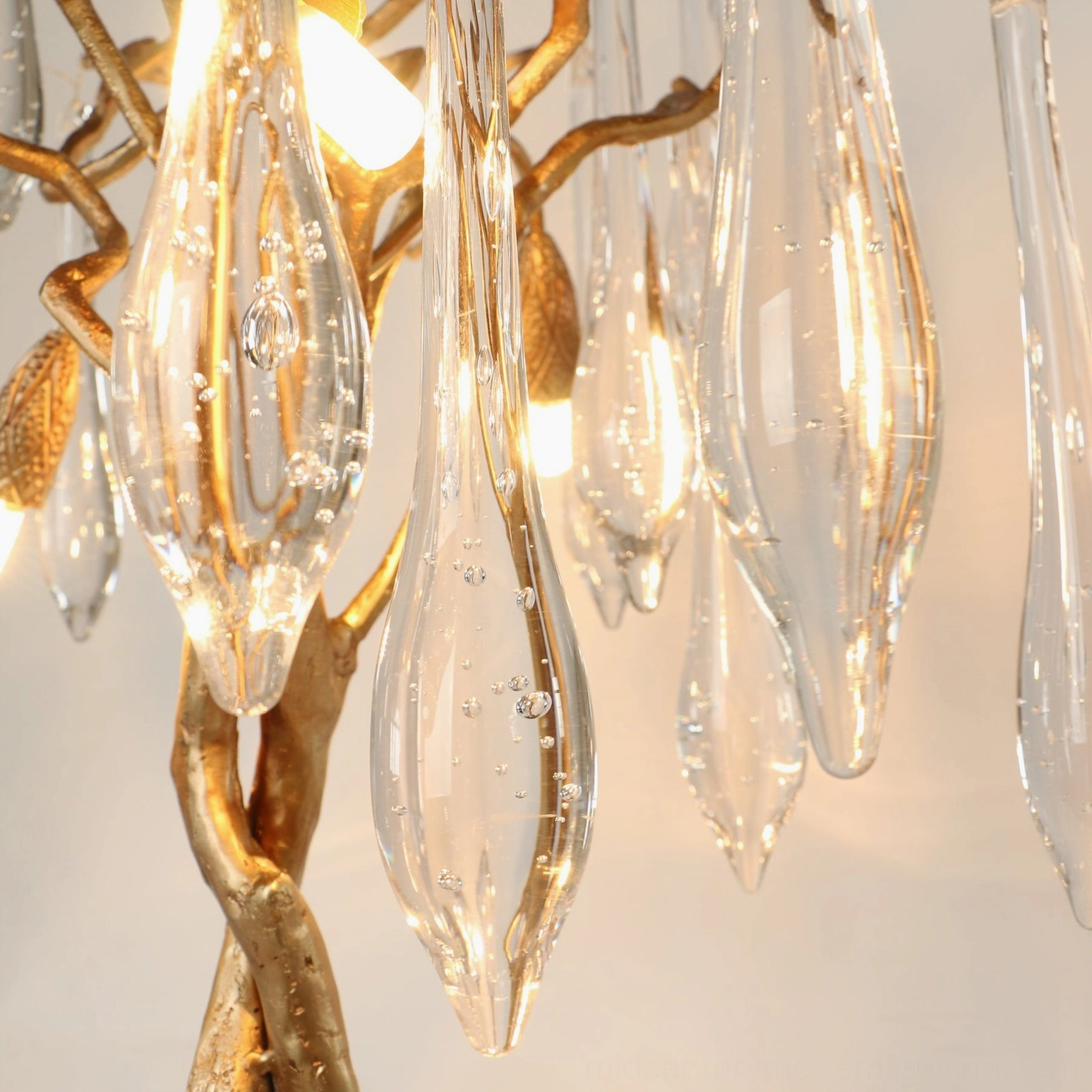 Detailed side view of textured gilded metal trunk and branch structure of mid-century modern table lamp