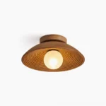 Teelin walnut ceiling light front studio view showing concentric groove pattern and frosted bulb
