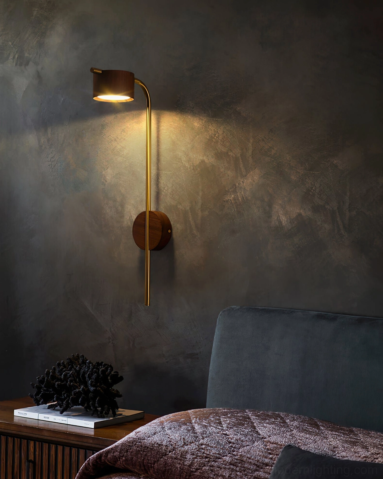 Front-facing view of Terence wall-mounted brass reading sconce with warm wood finish on gray wall