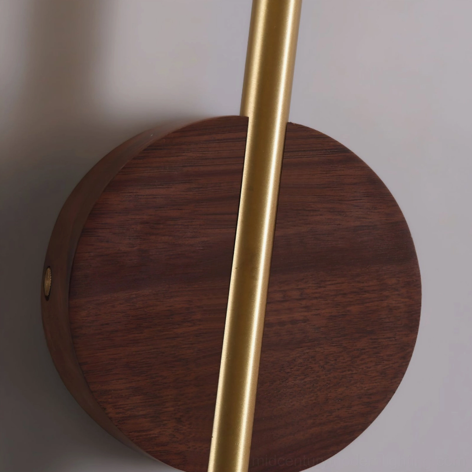 Detailed view of Terence circular brass wall mounting plate with connecting rod to wooden head