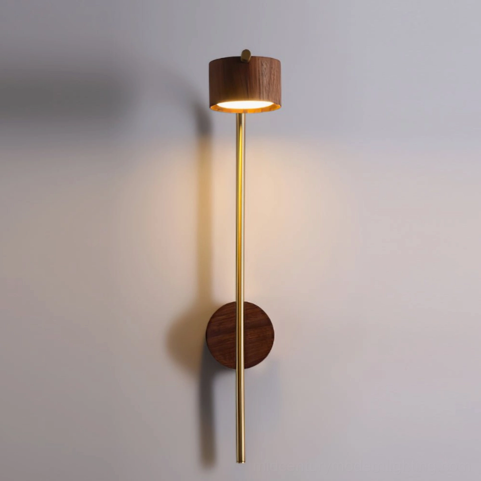 Tall arched brass wall sconce with round walnut head, extended arm design on neutral wall background