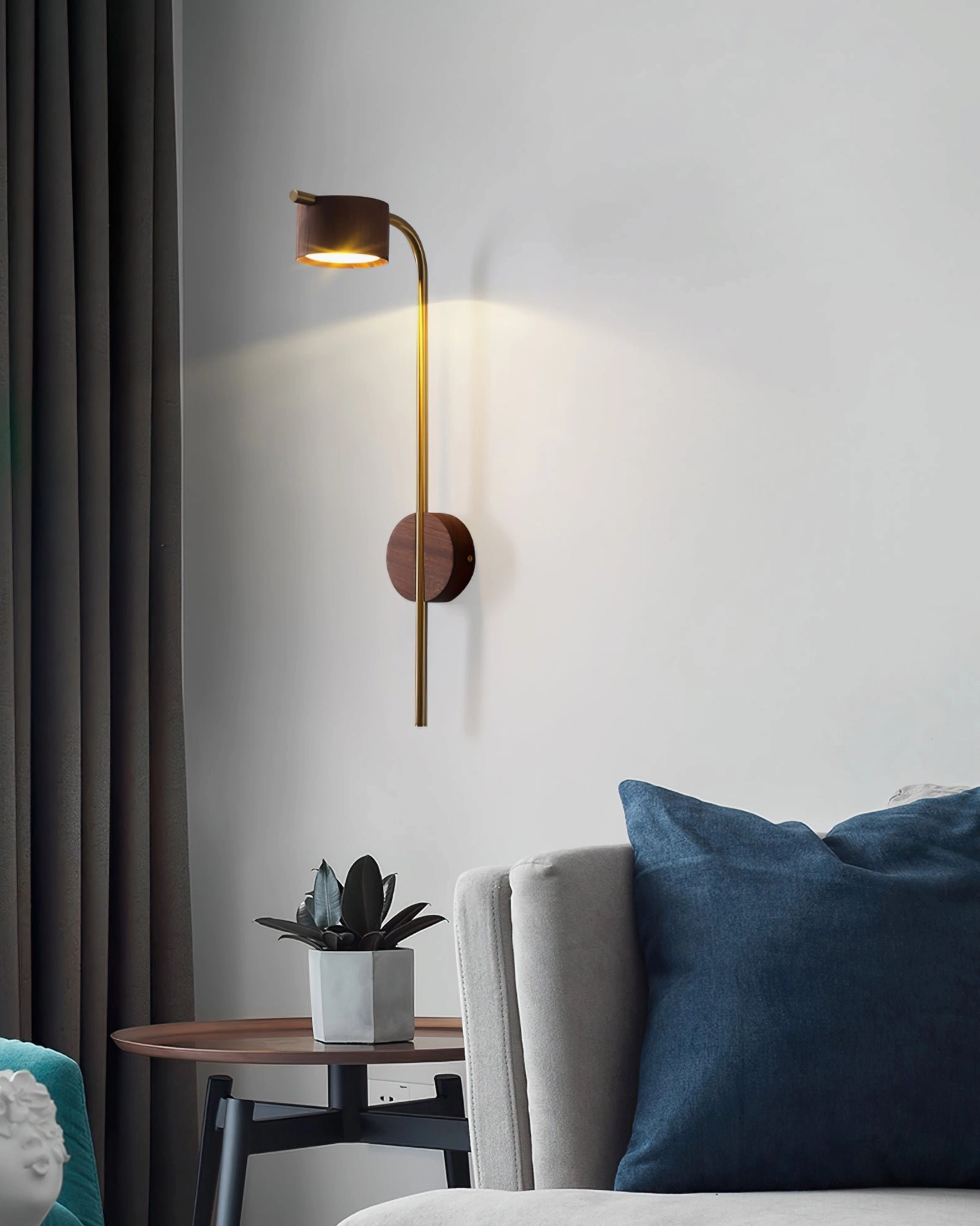 Terence wall sconce accent light in cozy living room with fabric sofa and potted plant side table